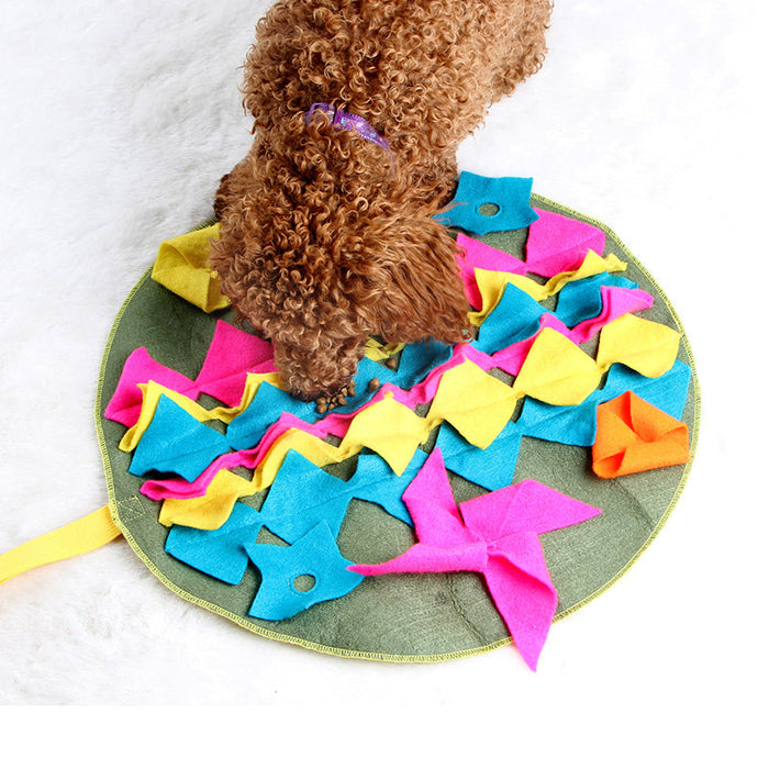 A fabric snuffle mat in use, hiding food in soft folds for foraging